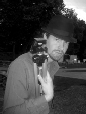 Michael - Fedora Holding Tripod