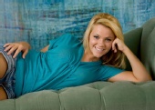 Chelsea Hahn - aqua shirt on couch